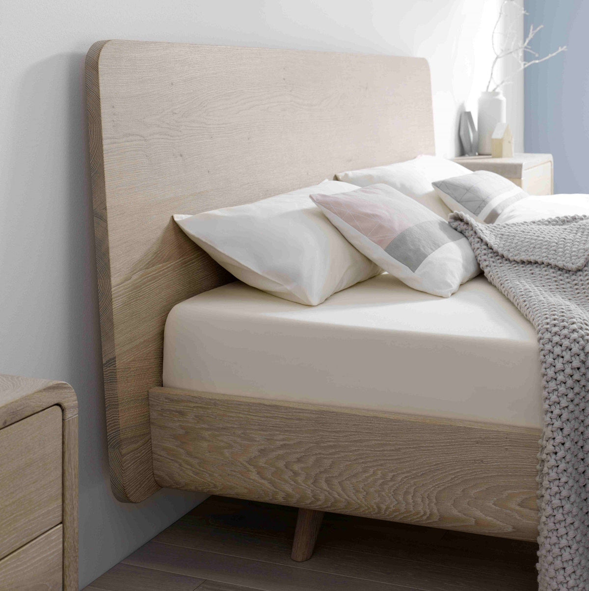 Kopfteil Detail vom Bett TALOS der Holzmanufaktur: Bett aus weiß geölter Eiche mit hohem Holzkopfteil im Boxspring Look.