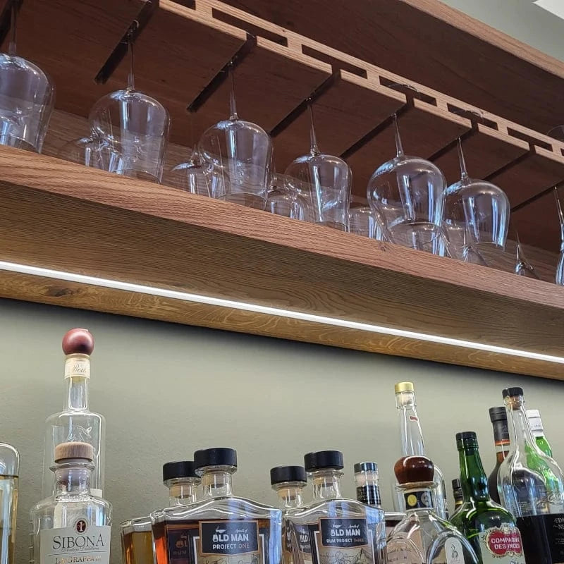 Beleuchtung unter der Halterung für Gläser in der Wohnzimmer Bar aus Eiche